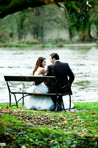 Wedding photograph of bride and groom by lake